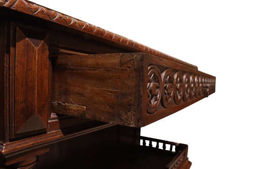 A French Henri II style dark oak enfilade with a carved frieze drawer, turned column supports, and an open lower shelf framed by a spindle rail. View VII