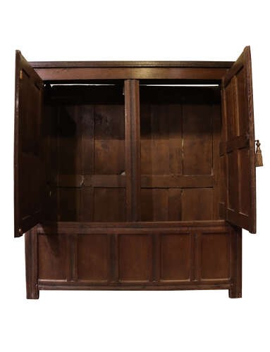 A seventeenth-century dark oak vestment cupboard featuring twin panelled doors with iron hinges above a lower panelled base. View III