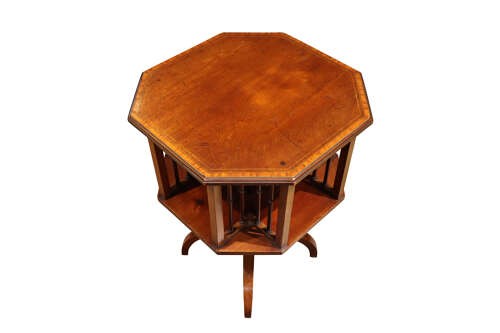 An Edwardian octagonal mahogany revolving bookcase with open spindle sides set upon a turned pedestal stand with tripod legs. View IV