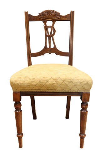 A pair of Victorian carved walnut side chairs with openwork backrests displaying a carved royal crown and monogram, resting on turned front legs with upholstered seats. View IV