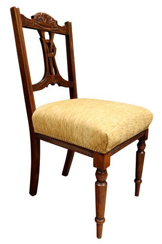 A pair of Victorian carved walnut side chairs with openwork backrests displaying a carved royal crown and monogram, resting on turned front legs with upholstered seats. View VII