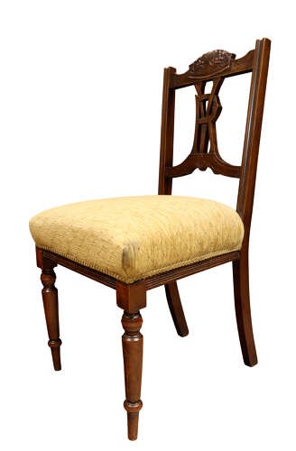 A pair of Victorian carved walnut side chairs with openwork backrests displaying a carved royal crown and monogram, resting on turned front legs with upholstered seats. View VIII