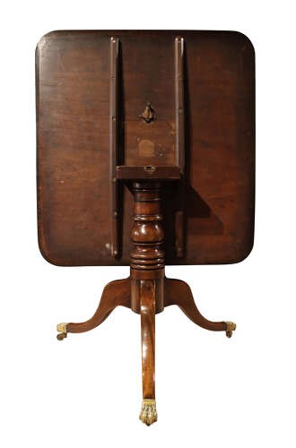 A George III mahogany pedestal supper table featuring a rounded square tilt top, turned central column, and splayed legs with brass paw castors. View IV