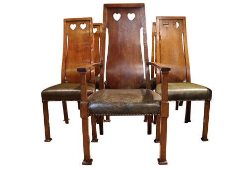 A set of six Arts and Crafts solid oak dining chairs featuring tall backsplats with heart-shaped cutouts and green leather seats with brass studding. View II