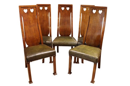 A set of six Arts and Crafts solid oak dining chairs featuring tall backsplats with heart-shaped cutouts and green leather seats with brass studding. View III