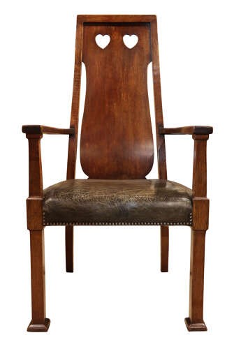 A set of six Arts and Crafts solid oak dining chairs featuring tall backsplats with heart-shaped cutouts and green leather seats with brass studding. View IX