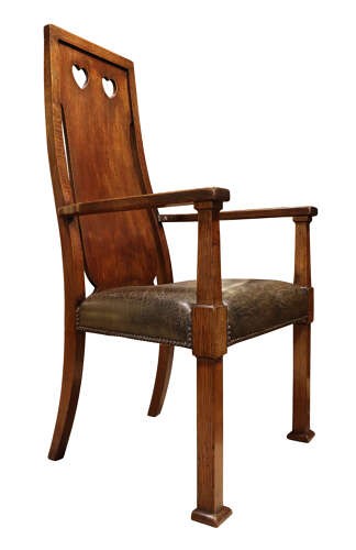 A set of six Arts and Crafts solid oak dining chairs featuring tall backsplats with heart-shaped cutouts and green leather seats with brass studding. View X
