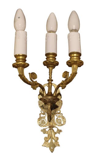 A pair of early 20th-century three-branch cast brass wall sconces featuring ornate acanthus leaf scrollwork and candle-style bulb fittings. View II