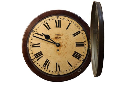 A circular early twentieth-century Bakelite wall clock with a cream dial, black Roman numerals, and black spatulate hands. View II