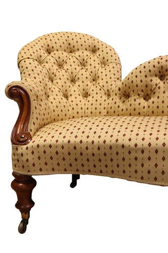 A Victorian mahogany double-ended settee featuring deep-buttoned patterned yellow upholstery, carved scroll arms, and turned legs with brass castors. View II