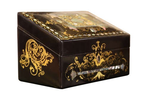 A black lacquered Victorian sloped stationery box adorned with gold leaf scrollwork and mother-of-pearl inlay. View VI