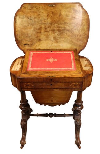 A Victorian burr walnut sewing table featuring intricate marquetry inlay on top, turned legs with carved feet, and a drop-down sewing well beneath a single drawer. View IV