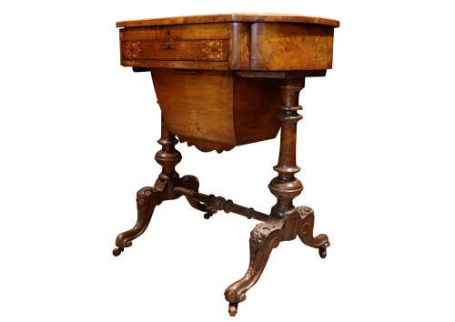 A Victorian burr walnut sewing table featuring intricate marquetry inlay on top, turned legs with carved feet, and a drop-down sewing well beneath a single drawer. View V