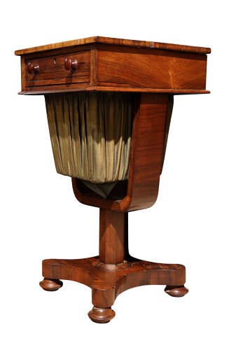 A William IV rosewood pedestal sewing table featuring a single top drawer, a pleated fabric work well suspended from a U-shaped frame, and a quadform base. View IV