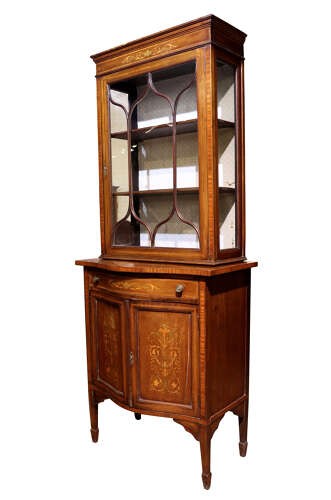 An Edwardian inlaid mahogany display cabinet featuring a glazed top door with geometric tracery above a lower cupboard with floral marquetry. View V