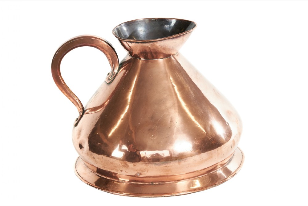 A large Victorian polished copper haystack jug featuring a wide conical body, flared rim, stepped base, and a sturdy riveted handle.