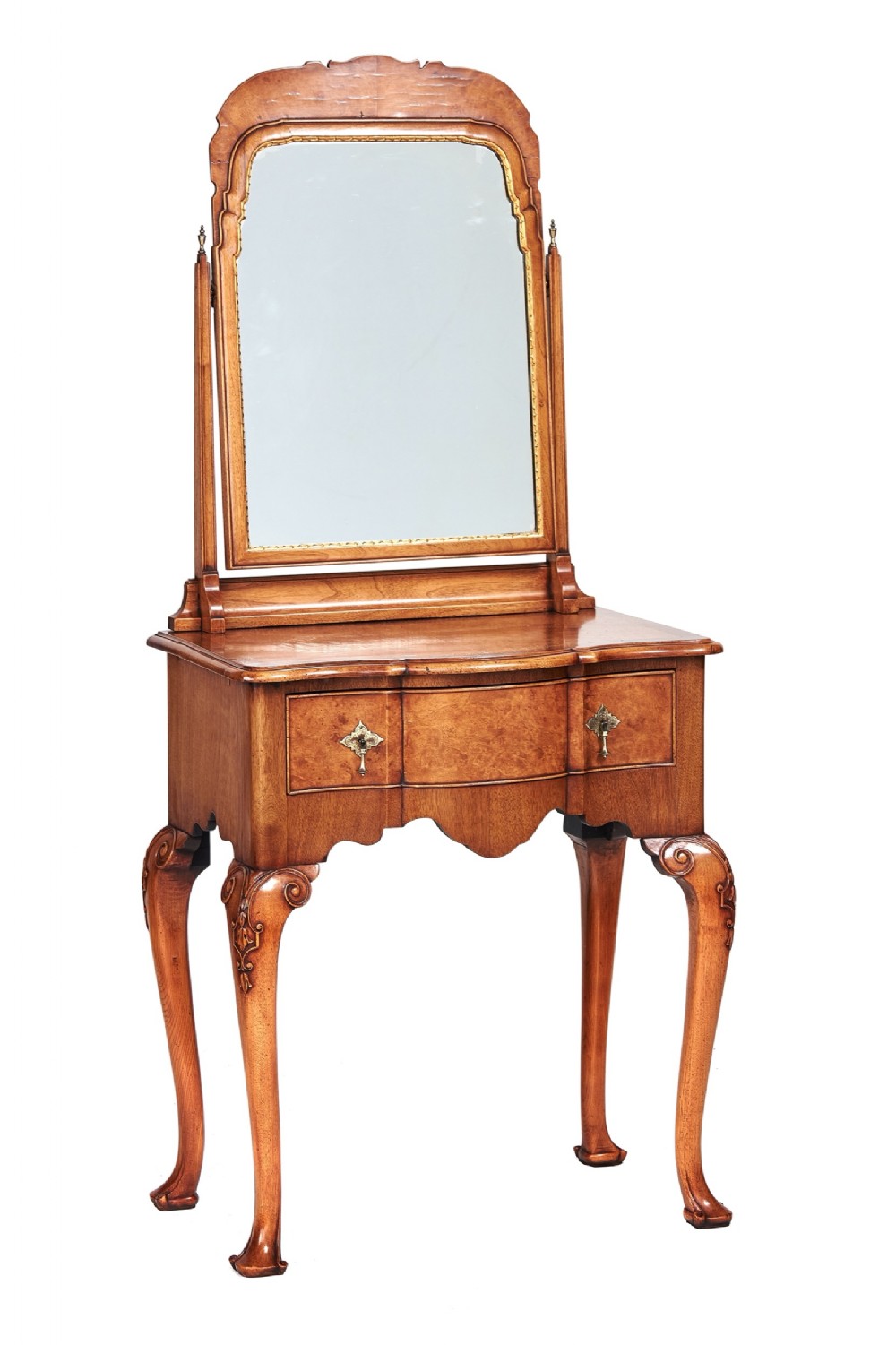 A Queen Anne Revival walnut dressing table featuring an attached arched swing mirror, carved cabriole legs, and a drawer with brass hardware.