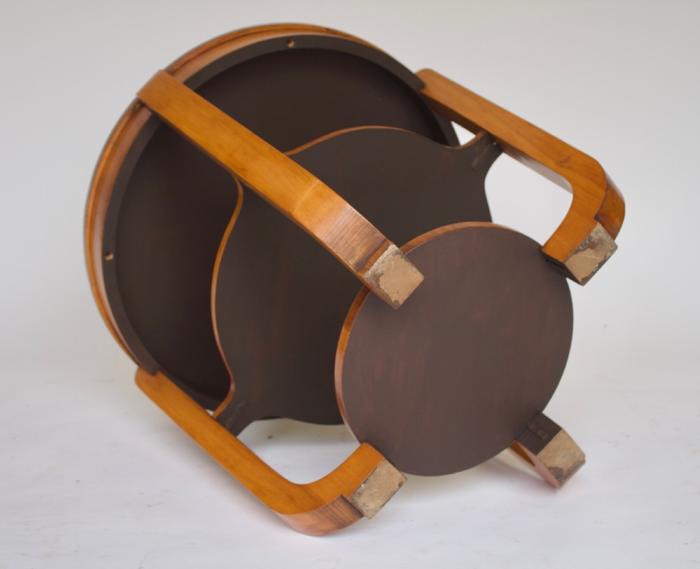 A circular Art Deco walnut side table featuring three tiers and curved leg supports. View II