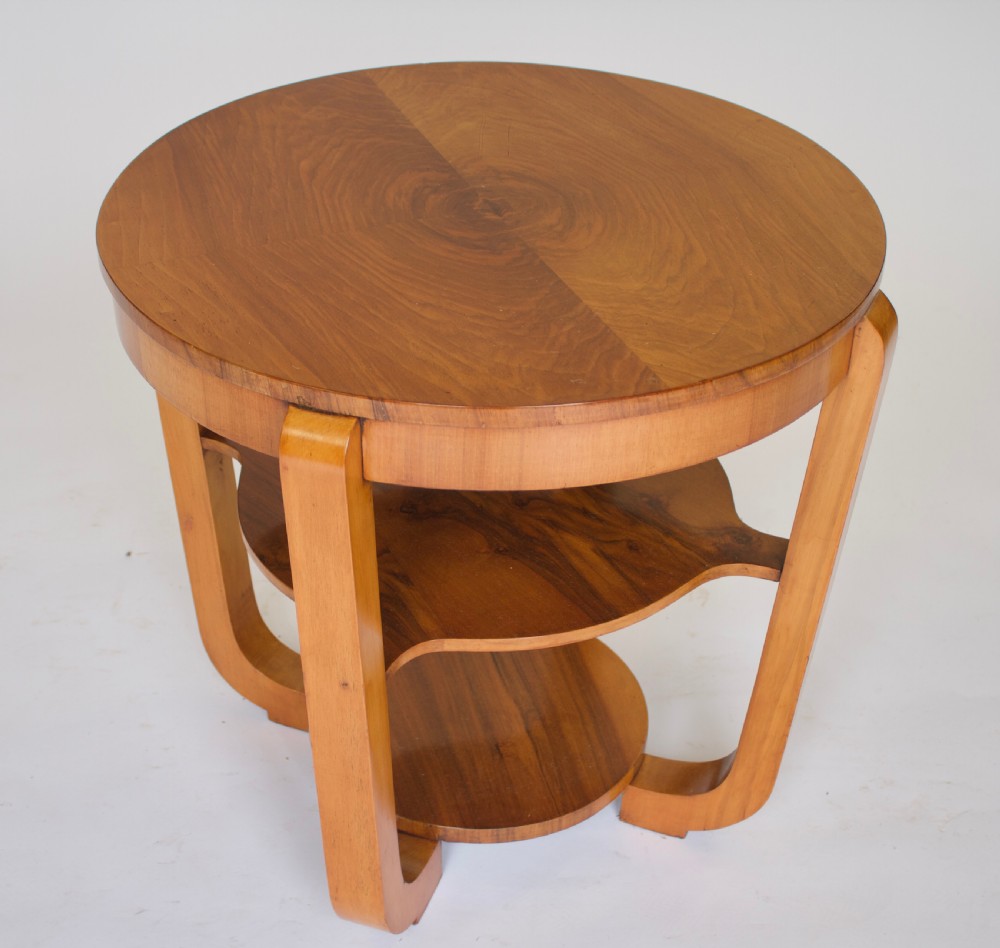 A circular Art Deco walnut side table featuring three tiers and curved leg supports. View III