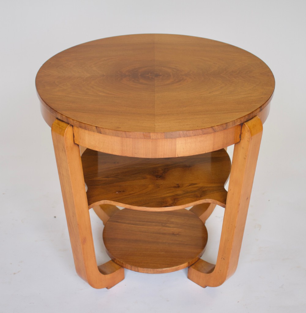 A circular Art Deco walnut side table featuring three tiers and curved leg supports. View V