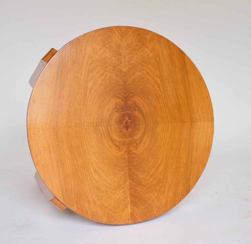 A circular Art Deco walnut side table featuring three tiers and curved leg supports. View VII