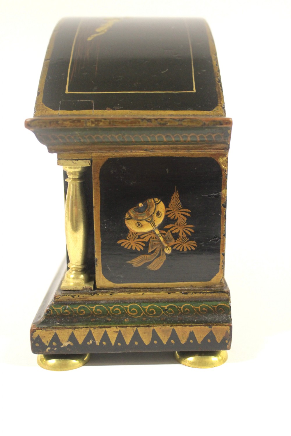 A 1920s arched black lacquered mantel clock decorated with gilded chinoiserie scenes, turned brass columns, and a cream dial with Roman numerals. View IX
