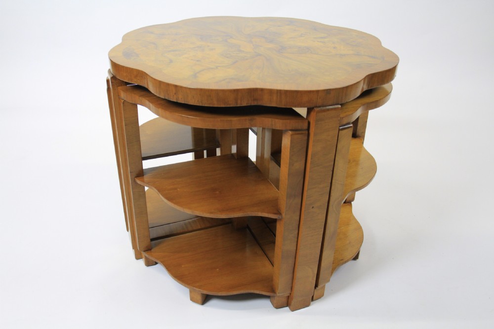 An Art Deco burr walnut nest of tables featuring a cloud-shaped top and four fitted segment side tables underneath. View VIII