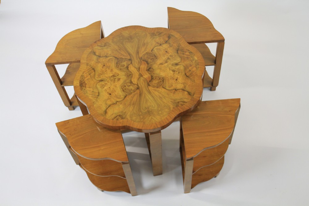 An Art Deco burr walnut nest of tables featuring a cloud-shaped top and four fitted segment side tables underneath. View X