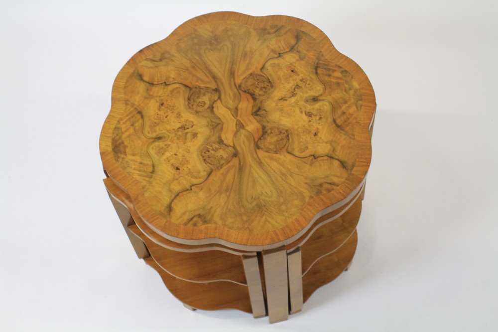 An Art Deco burr walnut nest of tables featuring a cloud-shaped top and four fitted segment side tables underneath. View XI
