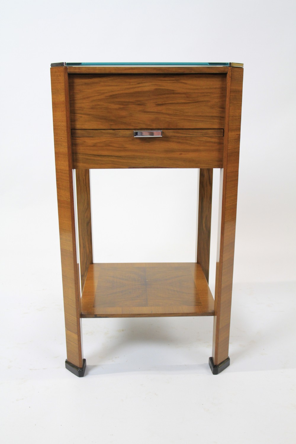 An Art Deco two-tier walnut side table featuring a square glass top, chrome corner grips, a lower shelf, and four pull-out maple slides extending from each side. View II