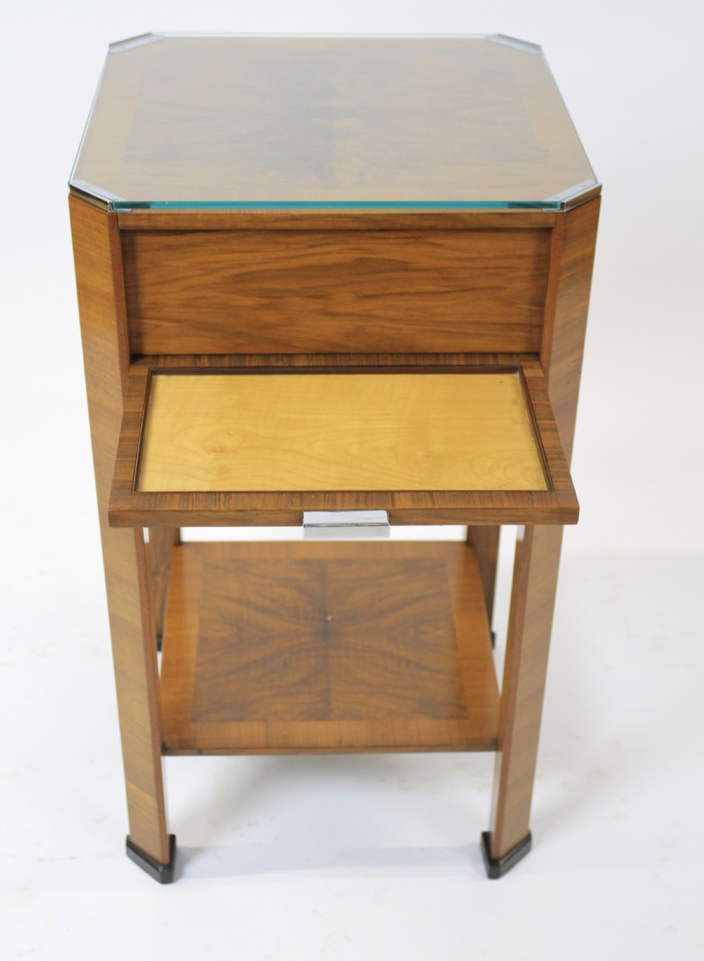 An Art Deco two-tier walnut side table featuring a square glass top, chrome corner grips, a lower shelf, and four pull-out maple slides extending from each side. View III
