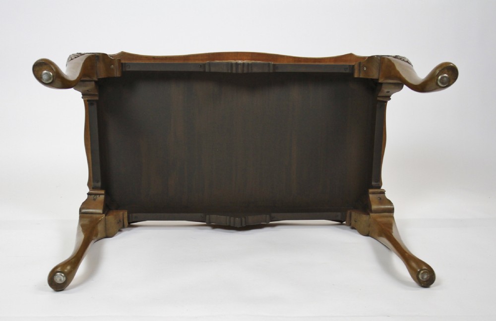 A low rectangular burr walnut coffee table featuring a serpentine edge, carved central shell motif, and four carved cabriole legs. View VI