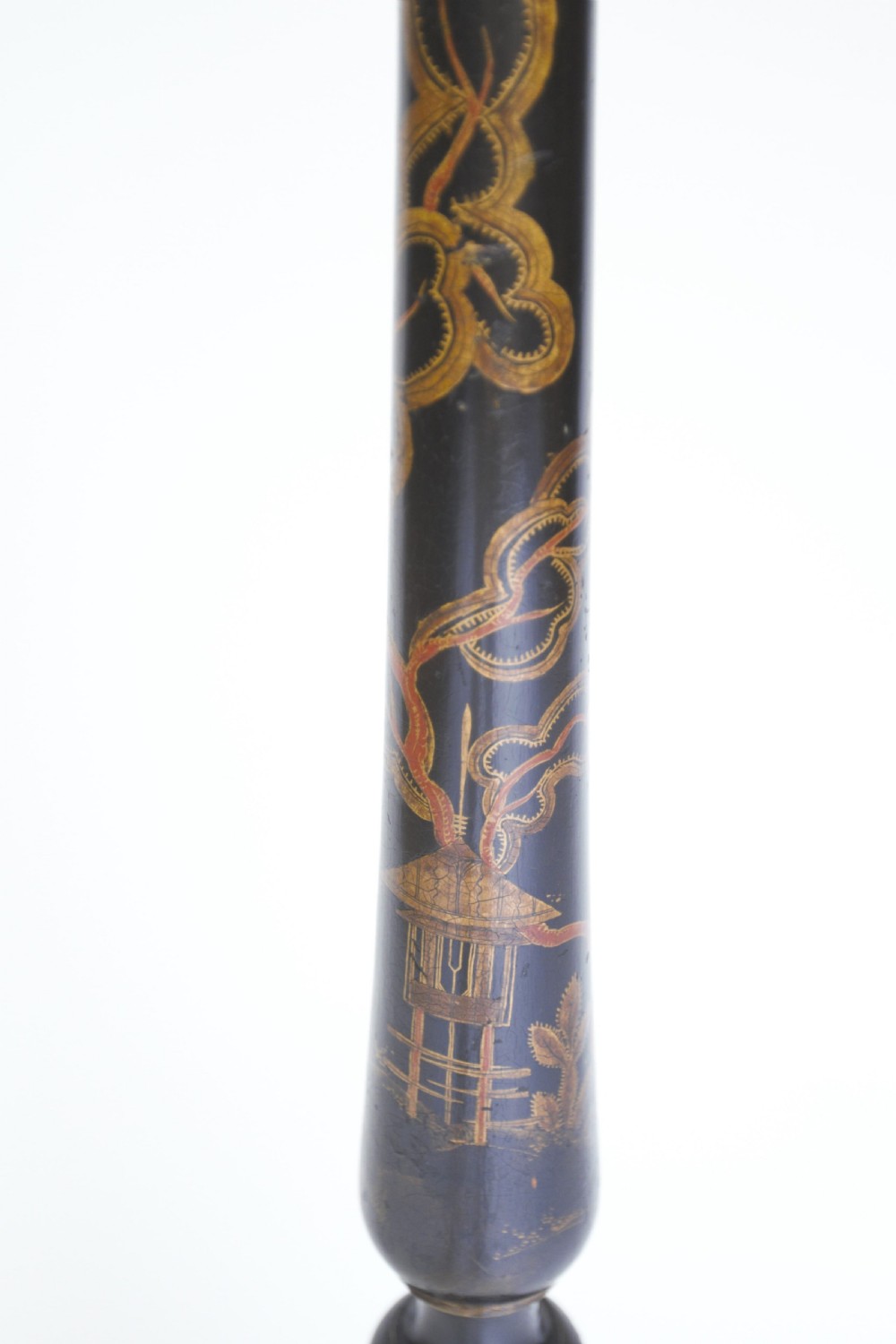 A tall black lacquered turned wooden standard lamp decorated with hand-painted gold floral Chinoiserie designs resting on a circular base. View III