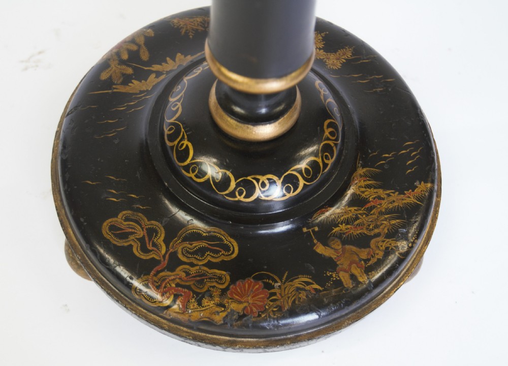 A tall black lacquered turned wooden standard lamp decorated with hand-painted gold floral Chinoiserie designs resting on a circular base. View VII