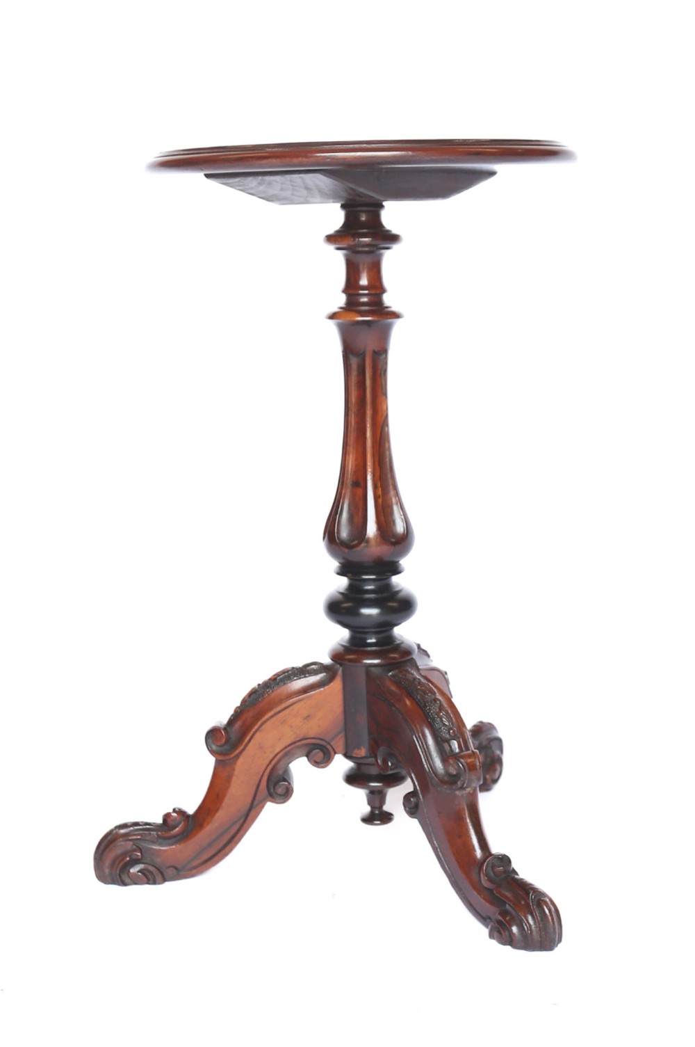 A Victorian rosewood lamp table featuring a circular top, a fluted turned pedestal, and three scroll-carved legs.