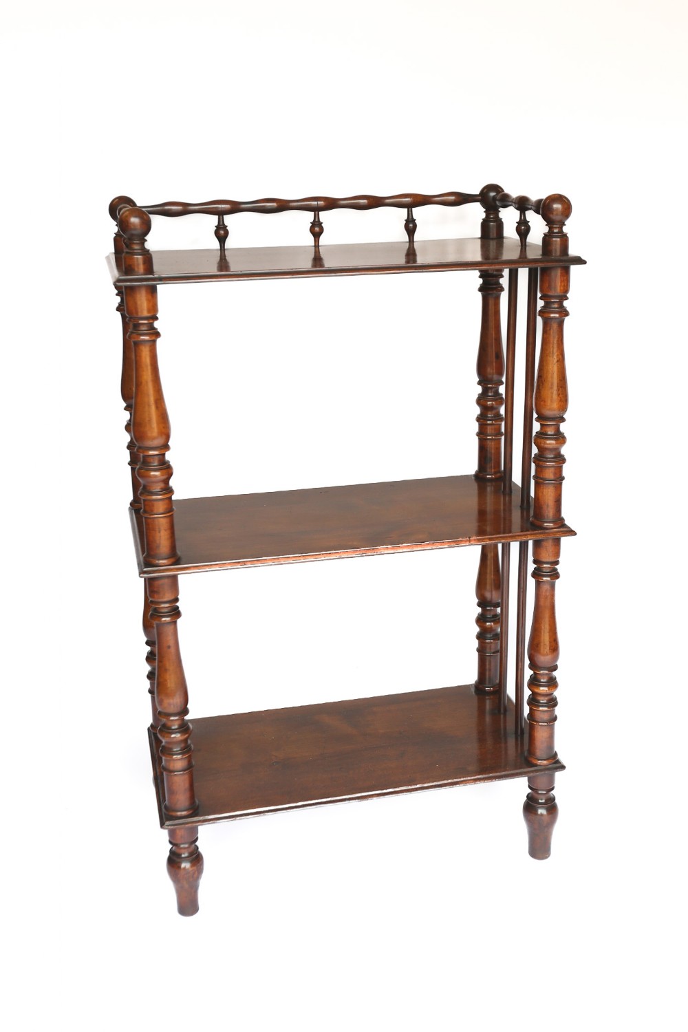 A three-tier Victorian fruitwood whatnot featuring turned corner supports and a decorative gallery rail along the top shelf.