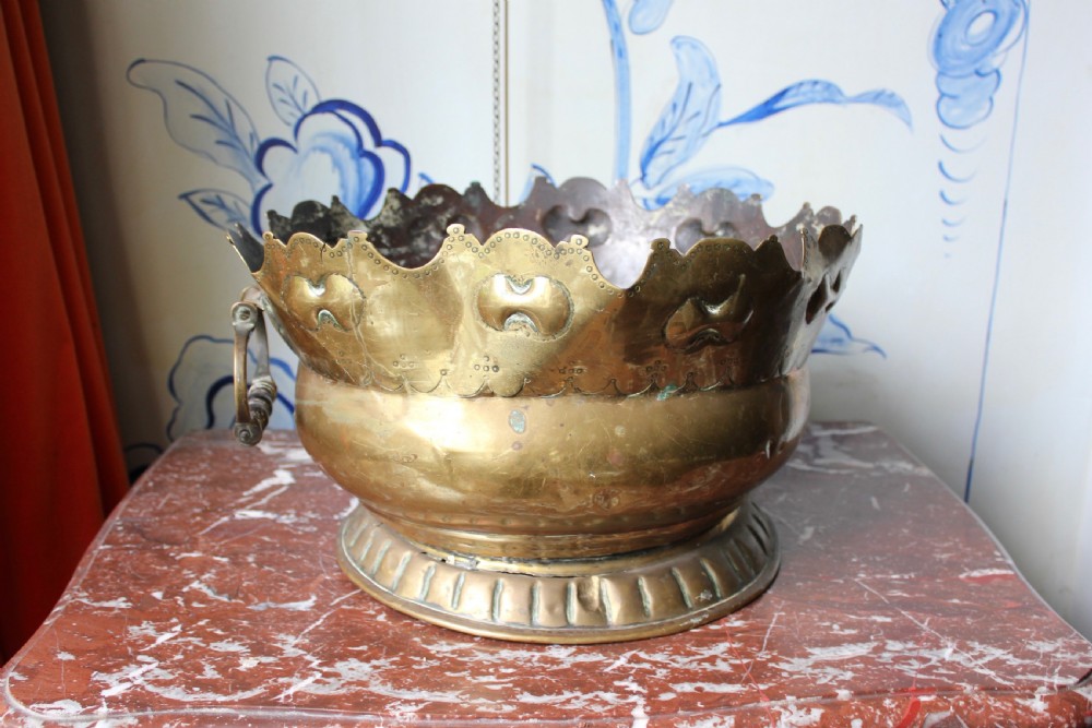 An 18th-century brass monteith bowl featuring a scalloped rim, embossed strapwork motifs, two side loop handles, and a gadrooned foot. View III