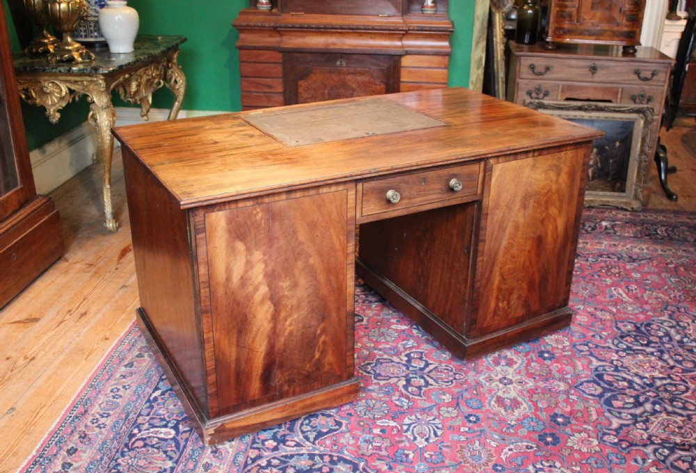 A Regency mahogany partners desk featuring twin pedestals with drawers, brass knobs, and a central adjustable writing slope. View II