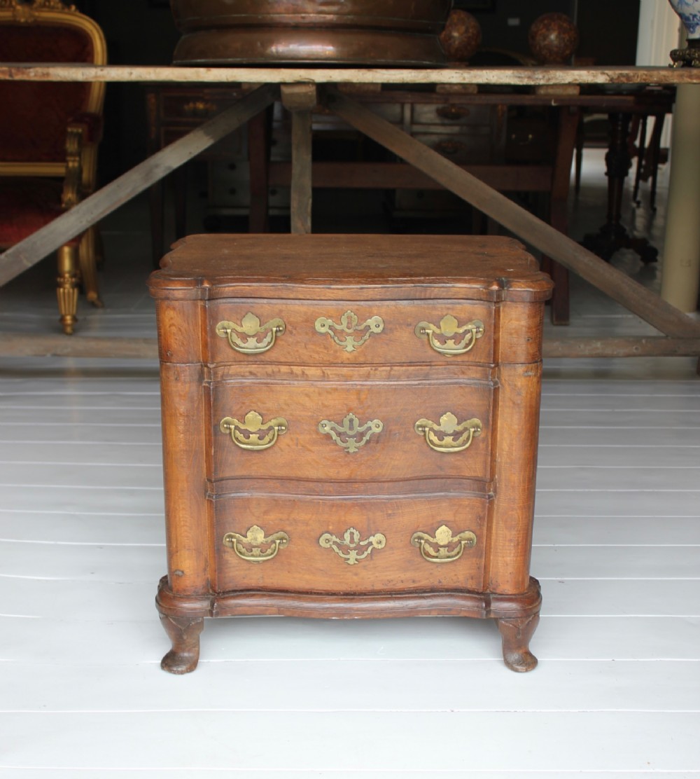 An 18th-century wooden close stool featuring false drawer fronts, brass drop handles, side carrying handles, and short turned feet. View II