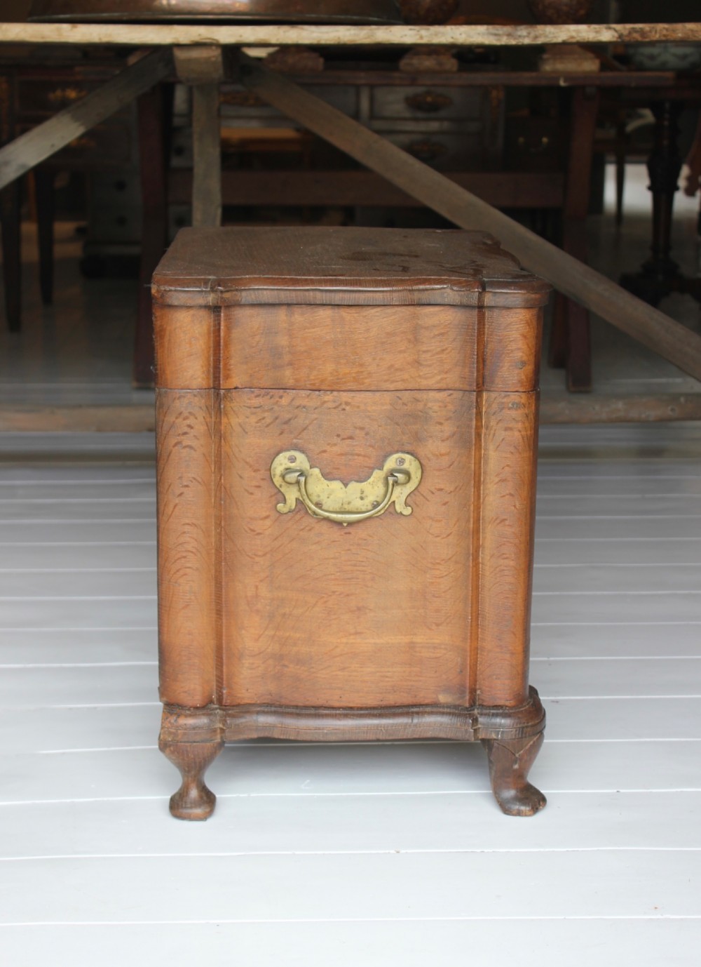 An 18th-century wooden close stool featuring false drawer fronts, brass drop handles, side carrying handles, and short turned feet. View VI