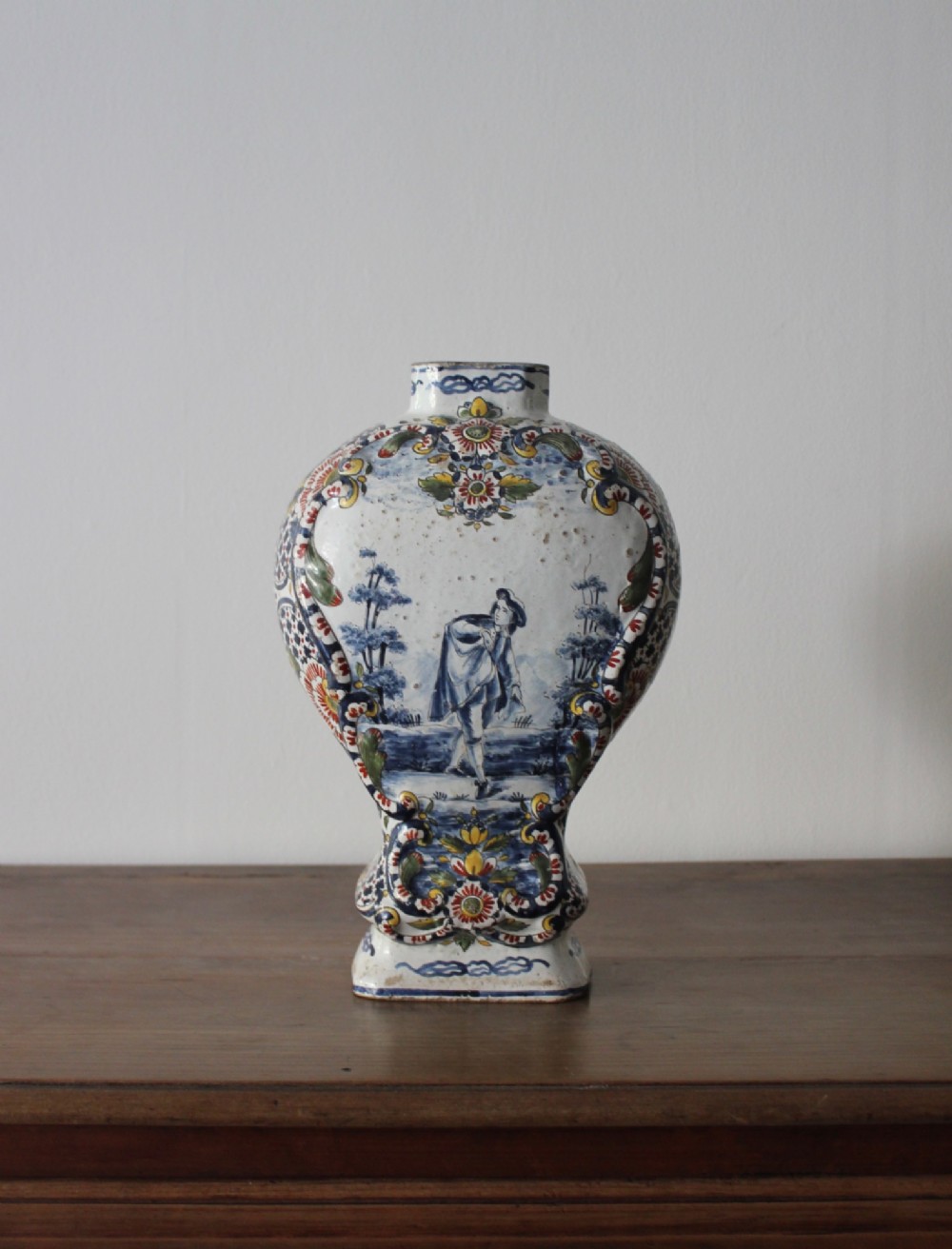 An eighteenth-century off-white tin-glazed ceramic vase decorated with hand-painted polychrome floral motifs across the front. View II