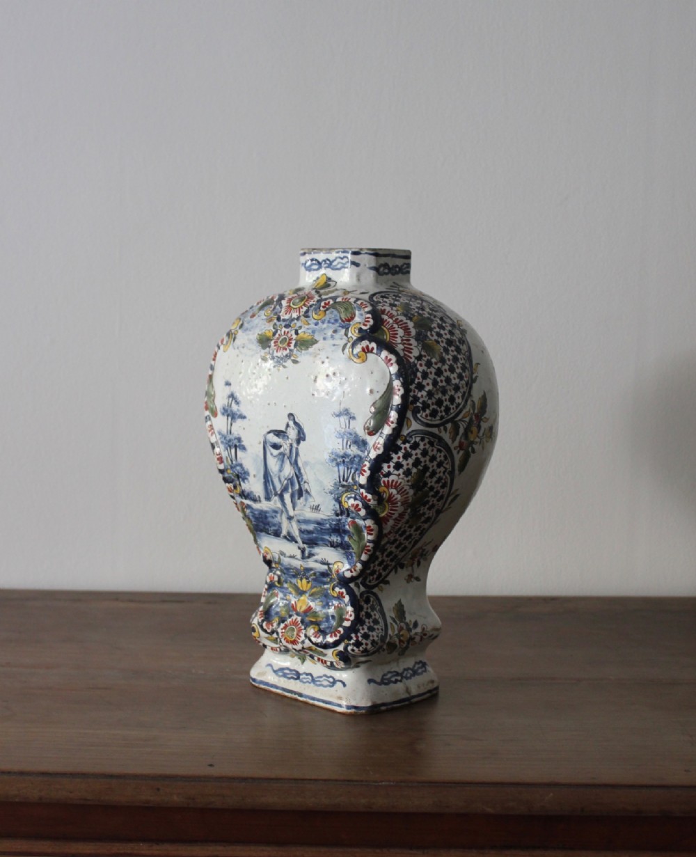 An eighteenth-century off-white tin-glazed ceramic vase decorated with hand-painted polychrome floral motifs across the front. View IV