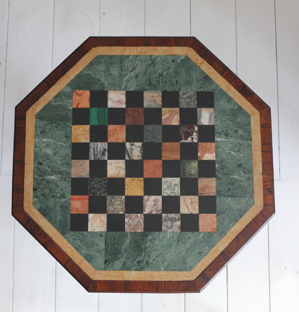 An early 19th-century Regency octagonal side table featuring an inlaid specimen marble chess top, an octagonal stem, and a triform base with carved claw feet. View IV