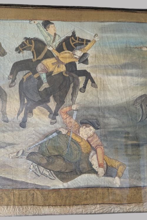 A horizontal framed antique painting on silk depicting figures on horseback engaged in a battle scene against a neutral background. View VI