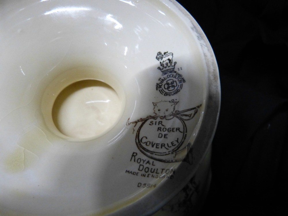 A footed ceramic bowl with a scalloped rim, featuring a printed pictorial scene of figures in a rural landscape on the interior surface. View IV
