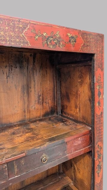 A 19th-century red lacquered Chinese open cabinet featuring hand-painted floral motifs on the outer frame and a central shelf with two small drawers. View VII