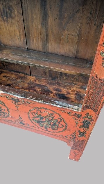 A 19th-century red lacquered Chinese open cabinet featuring hand-painted floral motifs on the outer frame and a central shelf with two small drawers. View VIII