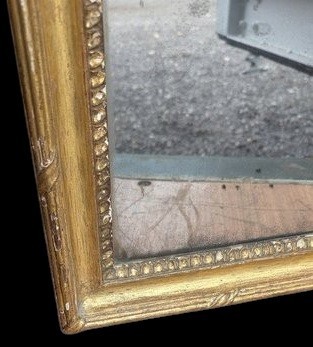 A late 19th-century rectangular Neoclassical giltwood wall mirror featuring an urn cresting and laurel branch swags. View VIII