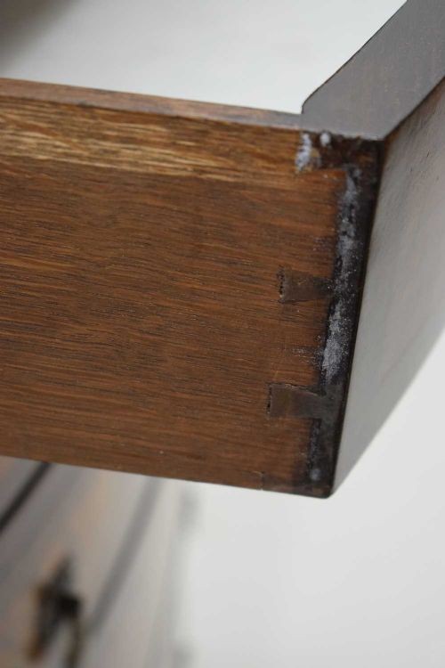 A tall Georgian style bowfront chest of drawers crafted in figured burr walnut with brass drop handles. View II