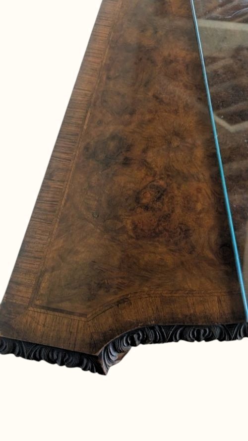 A semicircular burr walnut demi-lune sideboard featuring carved cabriole legs with ball-and-claw feet and decorative foliage carvings on the upright pilasters. View IX